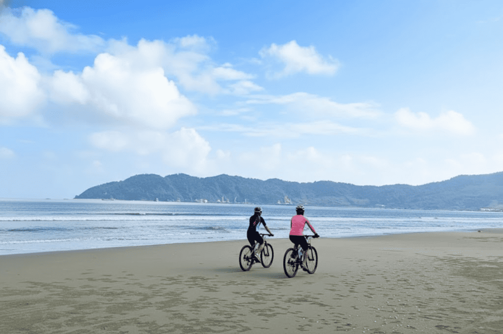 Relax at An Bang Beach with warm waters and moderate temperatures, perfect for swimming, sunbathing, and water sports